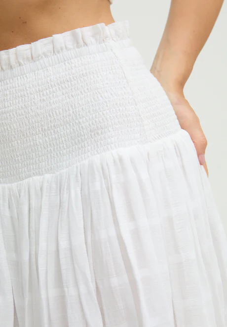 White Ruffled Waist Embroidered Midi Skirt Our embroidered midi skirt features traditional embroidery and cutout detailing.