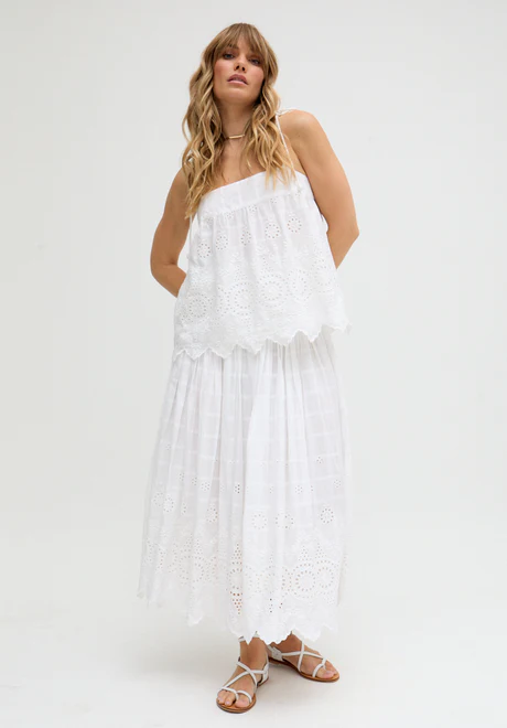 White Ruffled Waist Embroidered Midi Skirt Our embroidered midi skirt features traditional embroidery and cutout detailing.